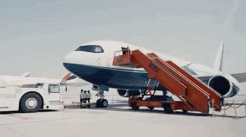 an airplane sitting on a runway with a ramp down