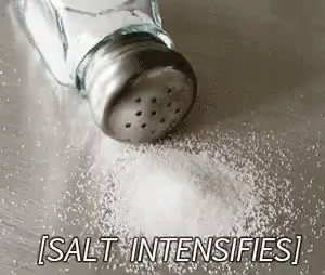 a salt shaker sits in the middle of a small pile of sugar