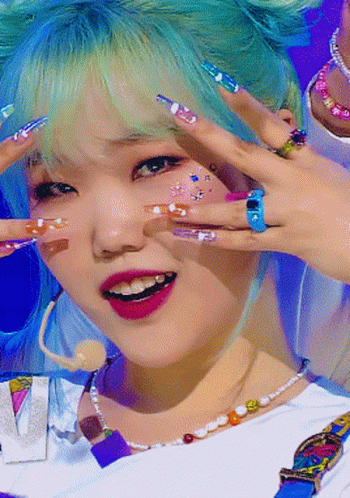 a girl with her hands up and colorful painted nails