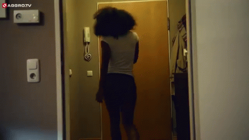 a woman standing in front of a bathroom door