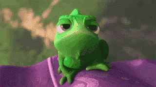 a green frog sitting on top of a purple substance
