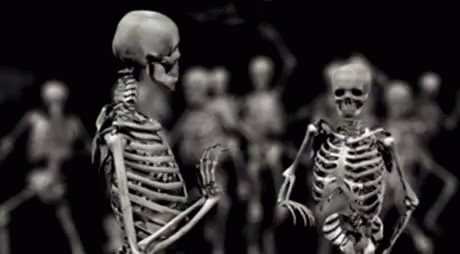 many skeletons are standing with their arms crossed