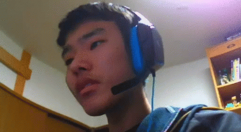 a boy wearing headphones in the corner of a room
