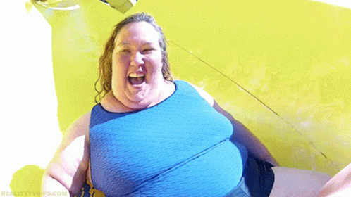 an overweight woman in a yellow top and shorts