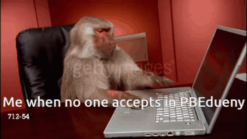 a monkey sitting in a chair at a desk typing on a laptop