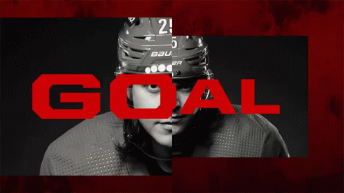 goal by a man with a hockey helmet on