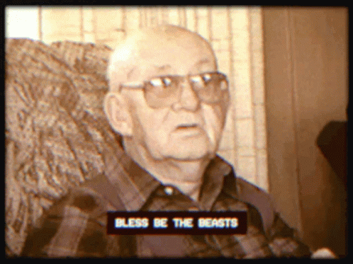 a man wearing glasses is on television, in the image has a message saying,