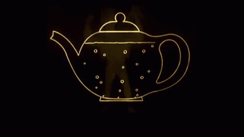 an illuminated tea pot in the dark