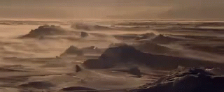 waves crashing into the shore of an island