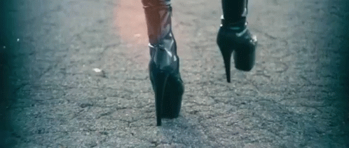 a person wearing high heels and a black jacket
