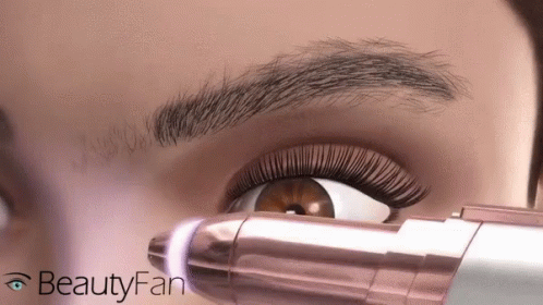 a lady using a camera with mascara brush on her eye