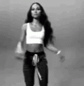 the doll is posed in a cropped top and high waisted jeans
