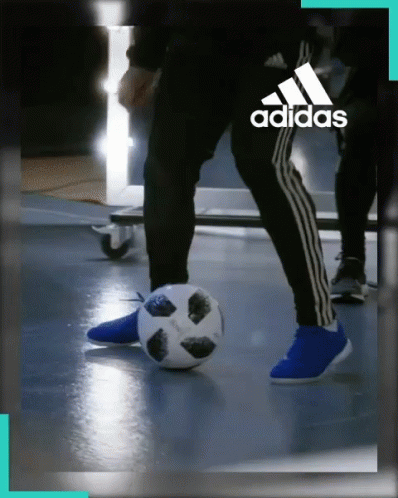 a person in black pants holding a soccer ball