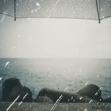 the view of a person laying on a bench under an umbrella
