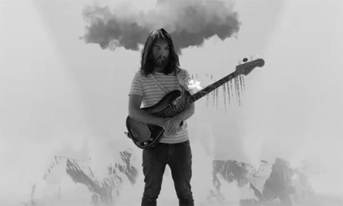 a man playing an electric guitar with a lot of smoke coming out