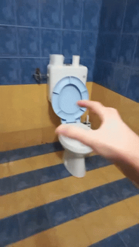 someone cleaning a toilet bowl with a hand in the bathroom