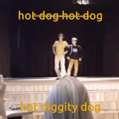 the two people in blue are standing on a stage with the caption dog  dog