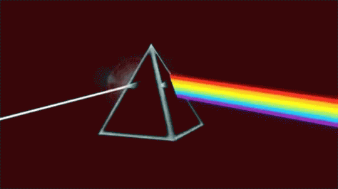 a white triangle is in the dark side of the rainbow