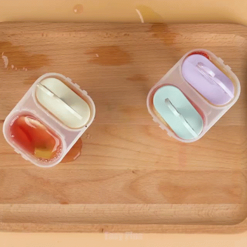 two small food containers are seen in this image