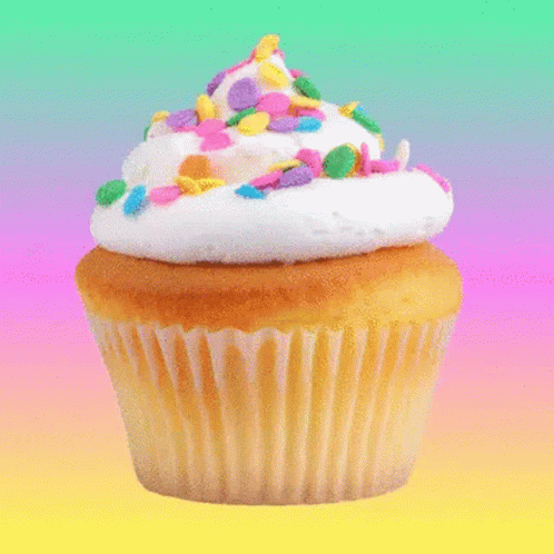a cupcake with white icing and sprinkles