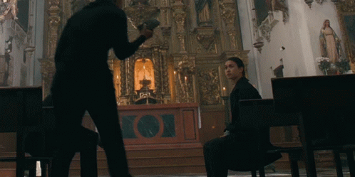 the priest is walking toward the alter while a man waits
