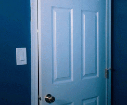 a white door in the corner of a room