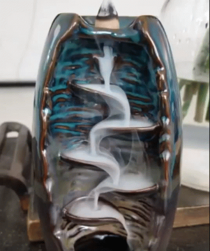 the inside of an artistic glass sculpture with liquid flowing out