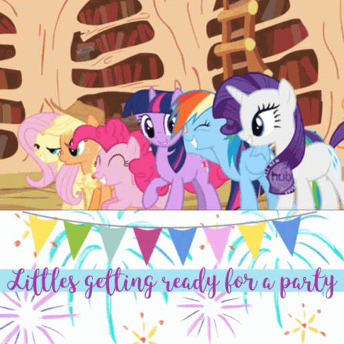 many little ponys standing on a table near some bunting