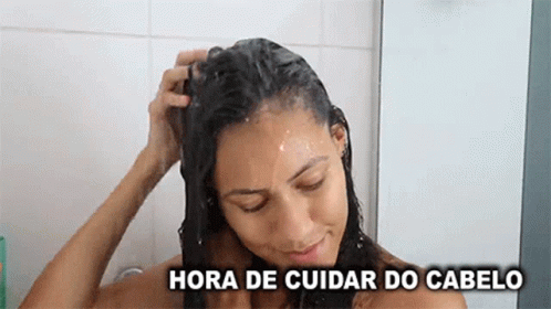 a woman that is drying her hair in the shower