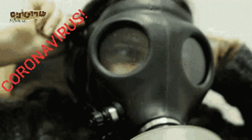 a man wearing a gas mask and hat