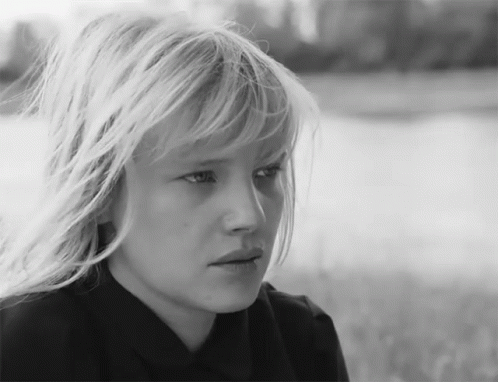 a black and white po of a blonde girl with bangs