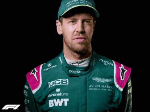a man in a race suit and cap