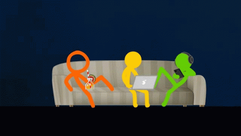three people sitting on a couch next to a laptop