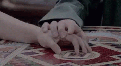 a person stretching their hands on top of a bed