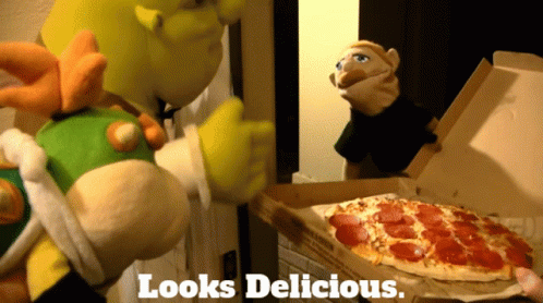 a blue stuffed toy stands next to an open pizza box with a pie inside