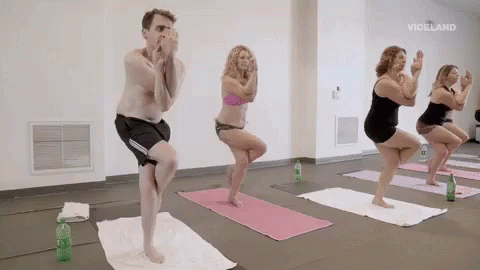 man standing on yoga mat in the middle of several poses