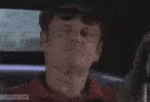 blurry image of a man's face behind a video camera