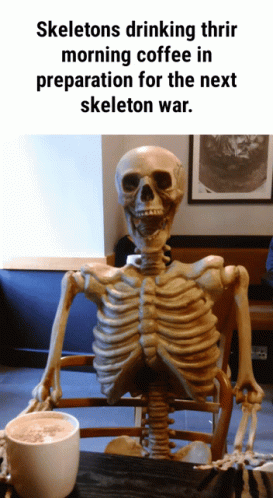the skeleton is sitting at a table with a cup of water
