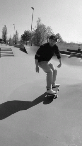 skate boarder in skate park riding the half pipe