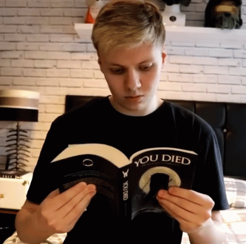 a boy wearing a shirt with an interconnected book in his hands