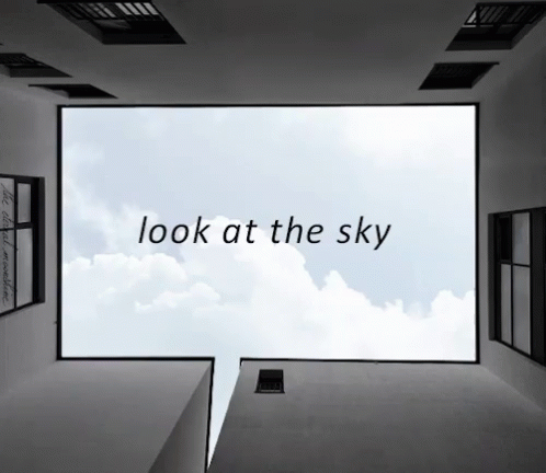 a black and white image of a sky with clouds that says look at the sky