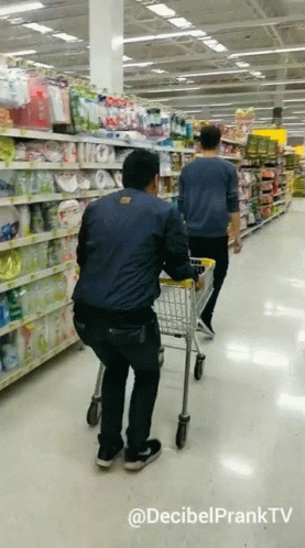 two men hing carts in a grocery store