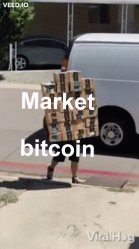 a man is holding up a box with a bitcoin on it
