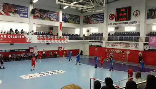 people watching while playing soccer on a court