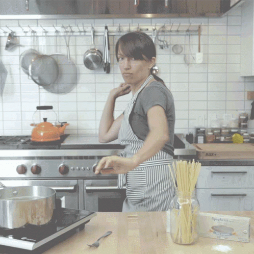 a young woman preparing food in a kitchen