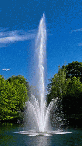 a pograph of a fountain in a park