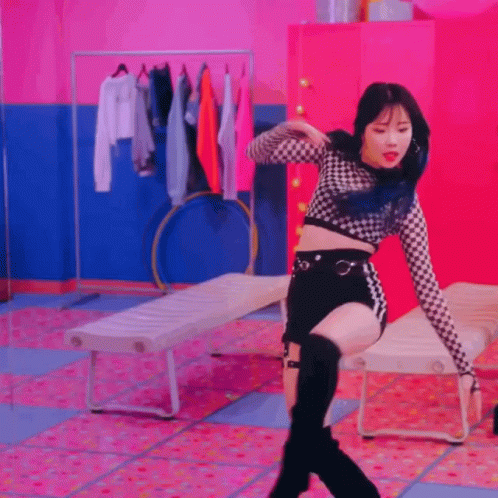 woman dancing in a dance studio wearing a black skirt and boots
