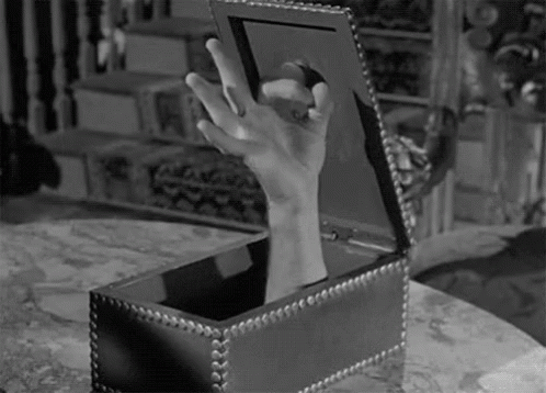 an antique box holds an arm and a finger in a scene from the film the house on the estate