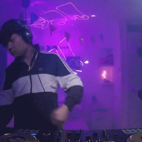 a dj mixing at a set in the background