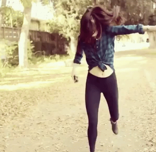 a girl in a tight legging is running in the street